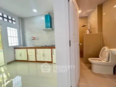 Modern kitchen and bathroom with sleek design and tiled flooring