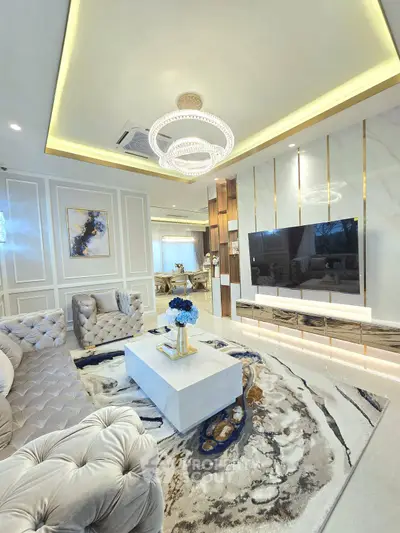 Luxurious living room with elegant decor and modern chandelier