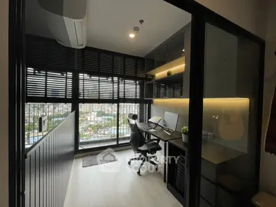 Modern study room with city view, featuring sleek desk and ergonomic chair, ideal for productivity.