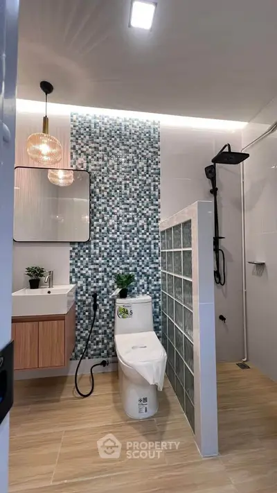 Modern bathroom with stylish mosaic tiles and sleek fixtures