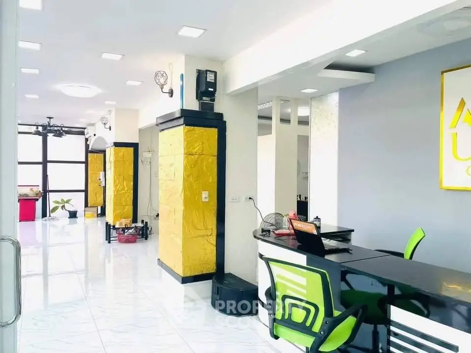 Modern office interior with sleek design and vibrant colors, featuring open layout and stylish furniture.