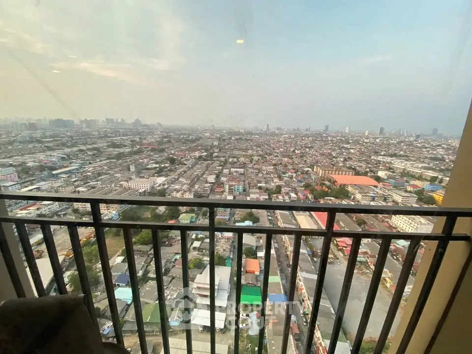 Stunning high-rise balcony view overlooking expansive cityscape, perfect for urban living enthusiasts.