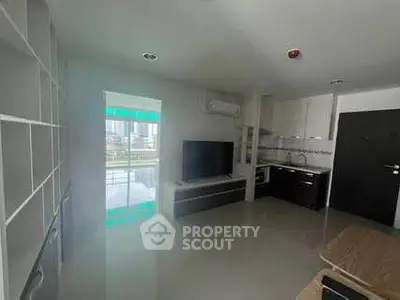 Modern open-layout kitchen and living area with sleek design and city view.