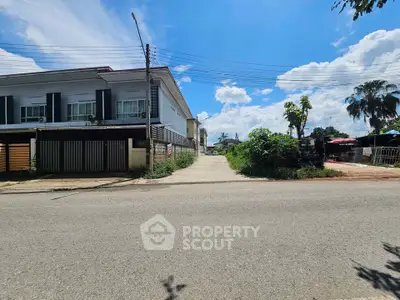 Modern residential building with clear blue sky and lush greenery, ideal for urban living.