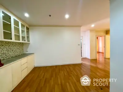 Spacious open layout kitchen with wooden flooring and modern cabinetry