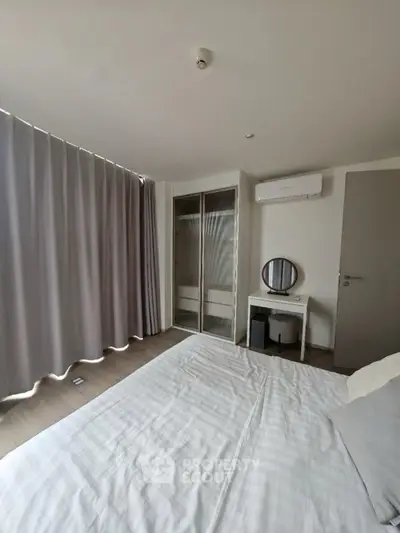 Modern bedroom with air conditioning and stylish decor in a cozy apartment.