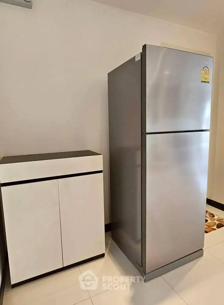 Modern kitchen with sleek refrigerator and stylish cabinet