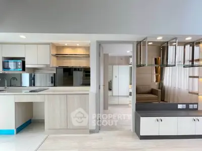 Modern open-layout kitchen with sleek cabinetry and integrated appliances