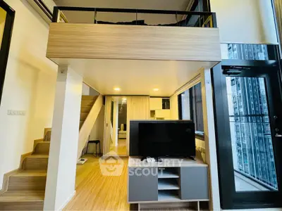 Modern loft apartment with mezzanine, stylish living area, and large windows.