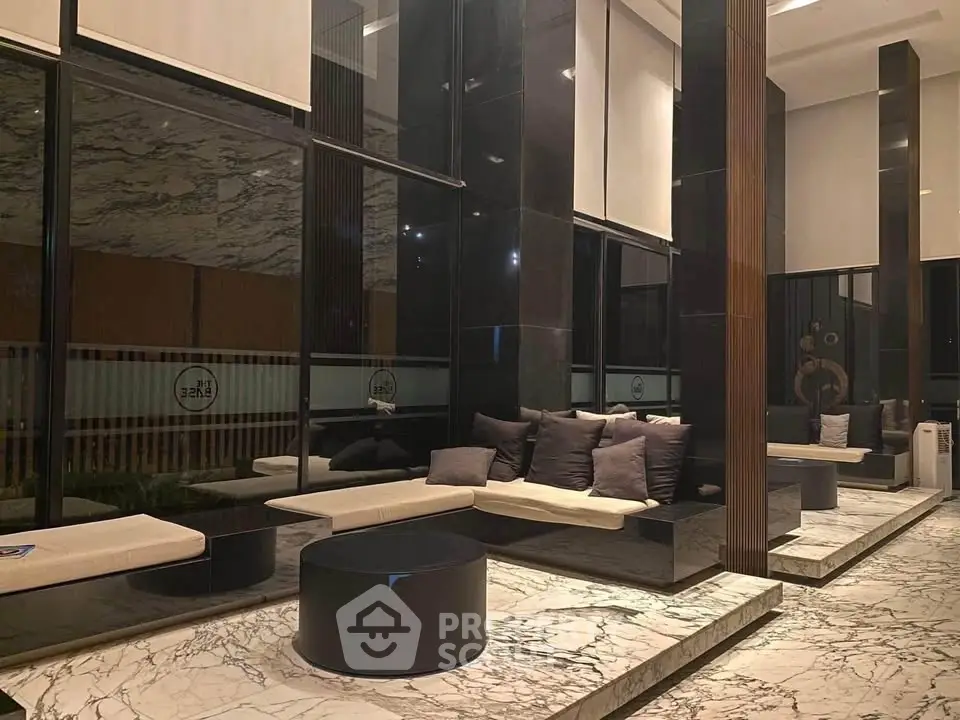 Luxurious modern lobby with marble floors and stylish seating in upscale building.
