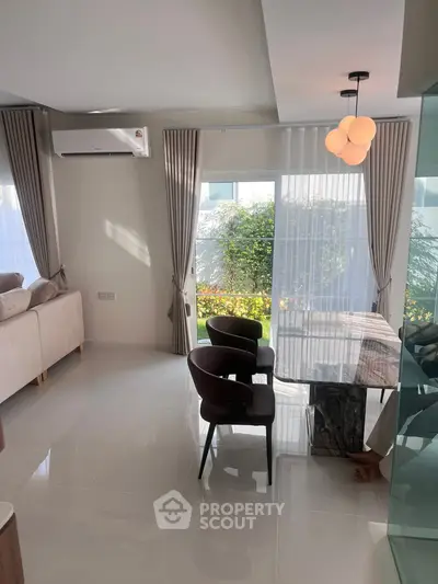 Modern living room with elegant dining area and large windows