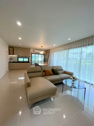 Spacious modern living room with open kitchen and large windows