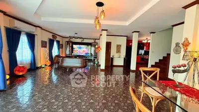 Spacious open-plan living room with modern decor and vibrant lighting