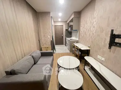 Modern compact living room with open kitchen layout and stylish furniture