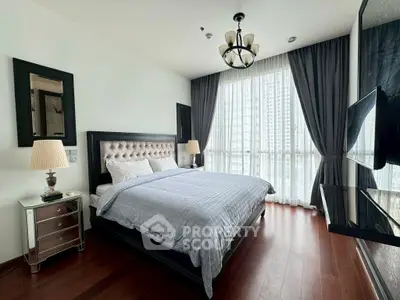 Luxurious bedroom with elegant decor and large window offering city view