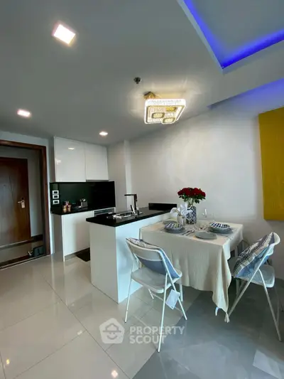 Modern kitchen with dining area, sleek design and elegant lighting, perfect for urban living.