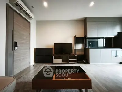 Modern living room with sleek furniture and open kitchen layout