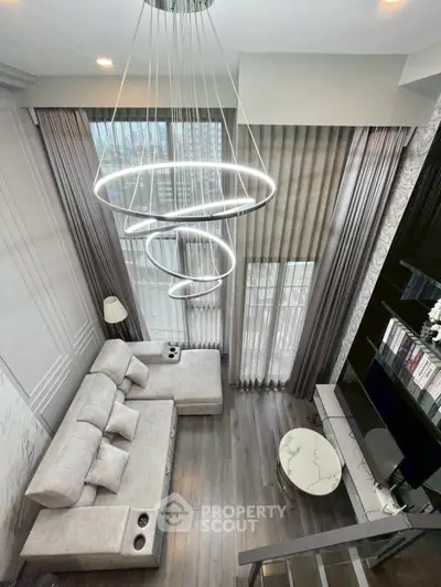 Luxurious modern living room with high ceiling and elegant chandelier