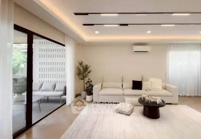 Spacious modern living room with elegant decor and large windows for natural light.