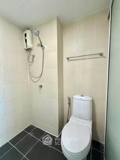 Modern bathroom with sleek tiles and shower setup