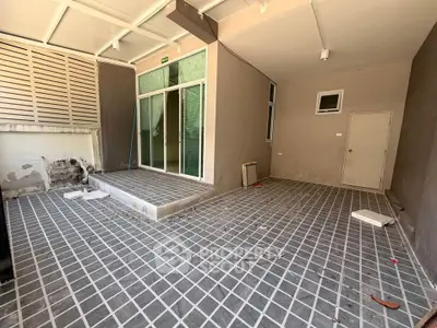 Spacious outdoor patio with tiled flooring and modern design, perfect for relaxation and entertainment.