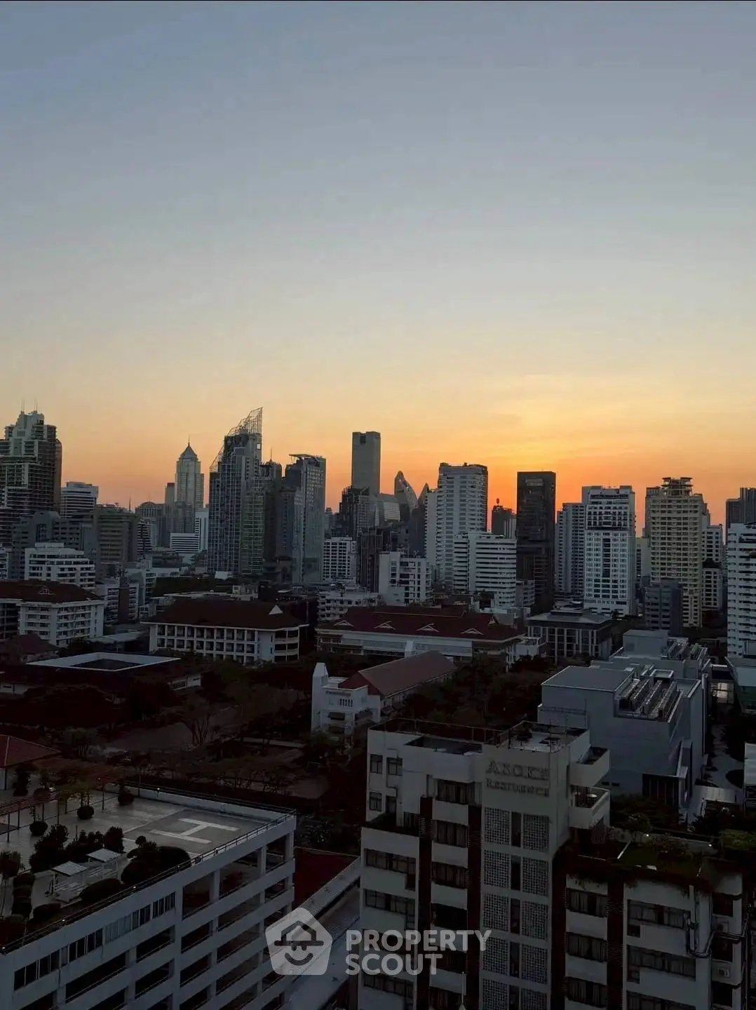 Stunning city skyline view at sunset with modern high-rise buildings.
