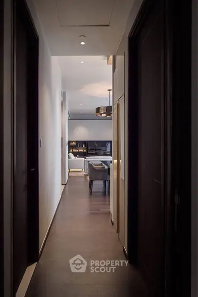 Elegant hallway leading to a modern living room with stylish decor and ambient lighting.