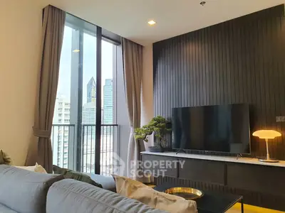 Modern living room with city view, sleek TV setup, and stylish decor.