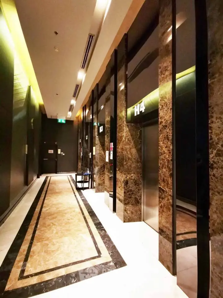 Luxurious marble elevator lobby with modern lighting and sleek design.