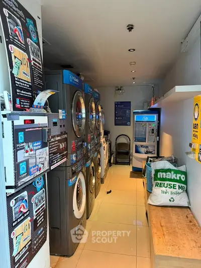 Modern laundry room with multiple washing machines and bright lighting