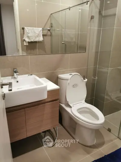 Modern bathroom with sleek fixtures and glass shower enclosure