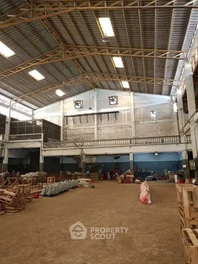 Spacious industrial warehouse with high ceilings and ample storage space.