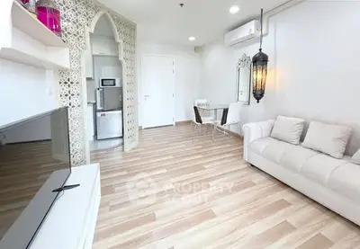 Stylish living room with modern decor and open kitchen layout