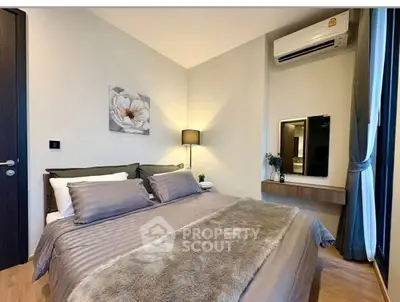 Elegant bedroom with cozy bedding and modern decor in a stylish apartment.