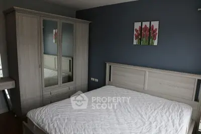 Modern bedroom with stylish wardrobe and cozy bed in elegant decor.