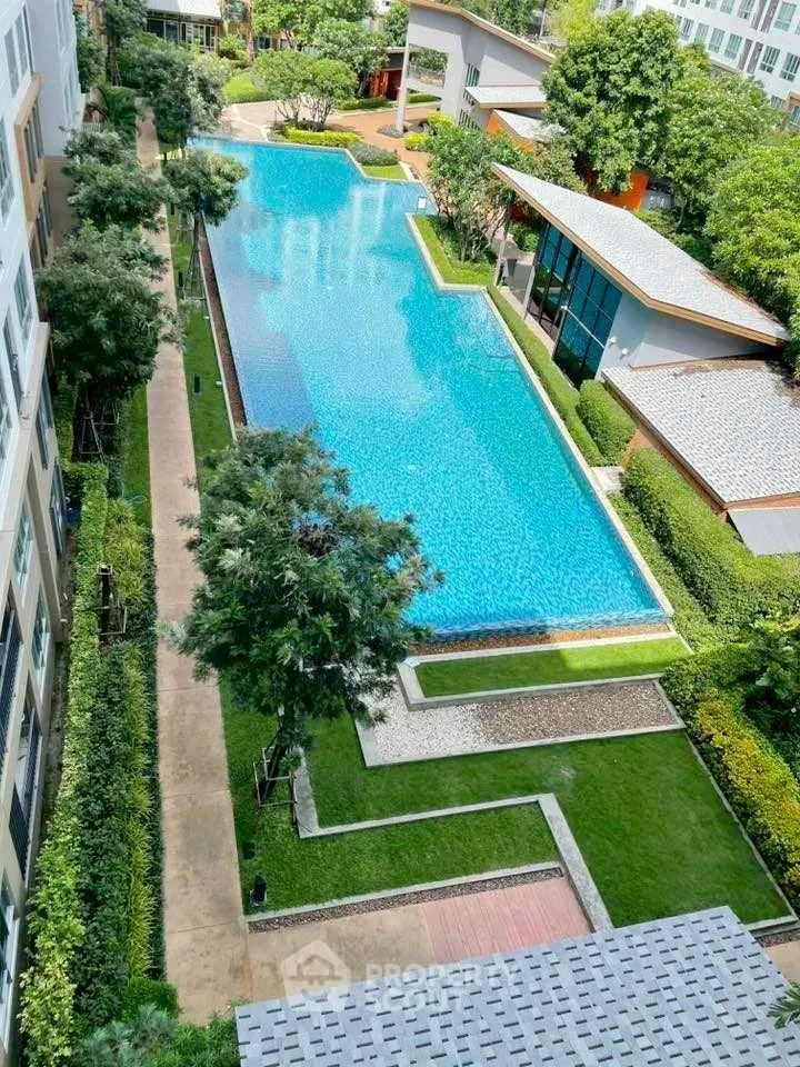 Luxurious apartment complex with stunning pool and lush greenery