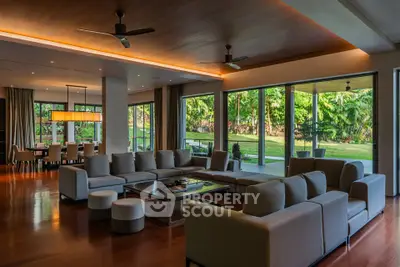 Luxurious open-plan living room with garden view and elegant furnishings