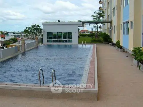 Luxurious apartment complex with rooftop pool and scenic views.