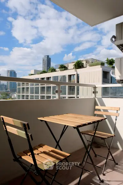 Charming balcony with city view and modern outdoor furniture, perfect for relaxation.