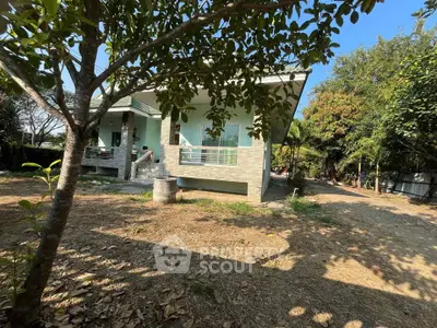 Charming single-story house with lush garden and spacious yard, perfect for family living.