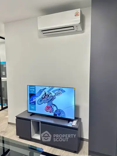 Modern living room with sleek TV unit and air conditioning