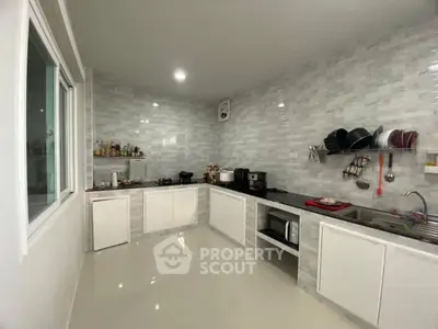 Modern kitchen with sleek cabinetry and appliances in a bright, spacious layout.