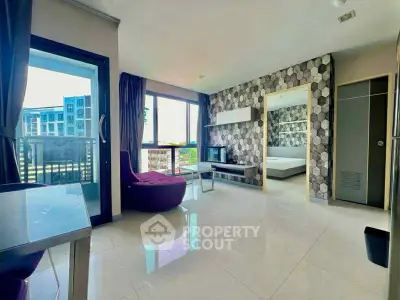 Modern living room with stylish decor and balcony view in a contemporary apartment.