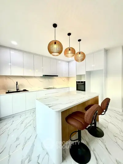 Luxurious modern kitchen with marble countertops and stylish pendant lighting