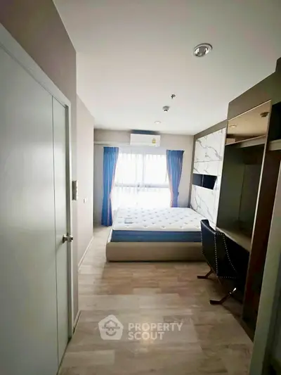 Modern bedroom with natural light, featuring a comfortable bed and stylish decor, perfect for relaxation.