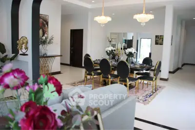 Luxurious open-plan living and dining area with elegant decor and chandeliers