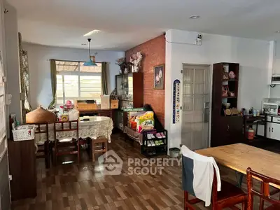 Spacious dining area with wooden flooring and ample natural light, perfect for family gatherings.