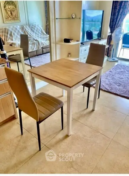 Cozy living room with dining area and balcony view, perfect for modern living.