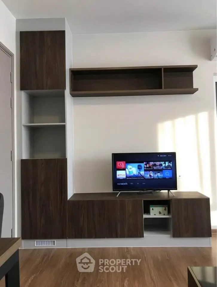 Modern living room with sleek wooden TV cabinet and wall-mounted shelves, perfect for stylish urban living.