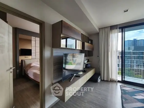 Modern living room with TV and balcony view in a stylish apartment